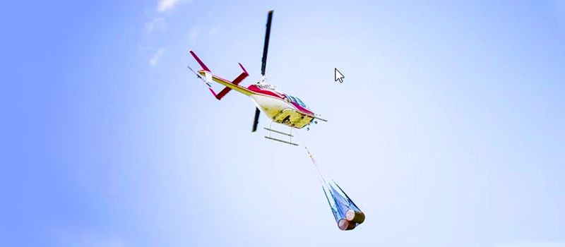 Helicopter using a longline and cargo net to transport a load